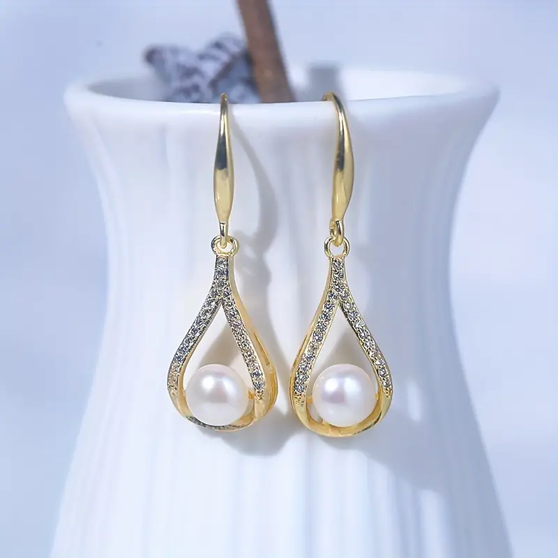 Gold earrings with white pearl and diamonds